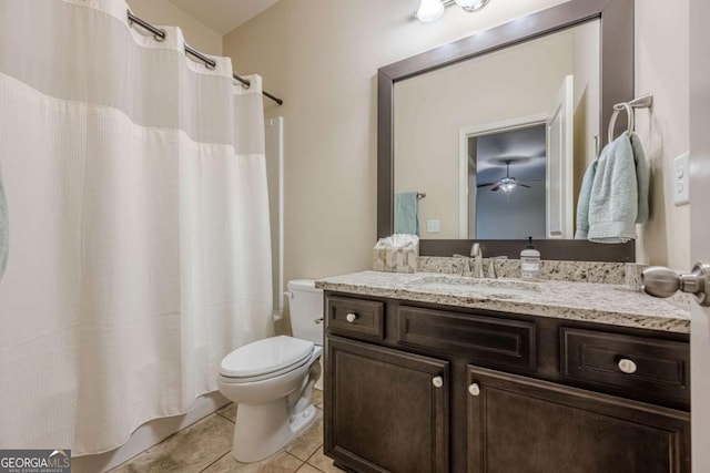 bathroom with tile patterned flooring, vanity, a shower with shower curtain, and toilet