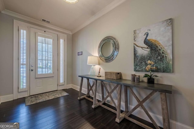 foyer with ornamental molding, vaulted ceiling, and dark hardwood / wood-style flooring