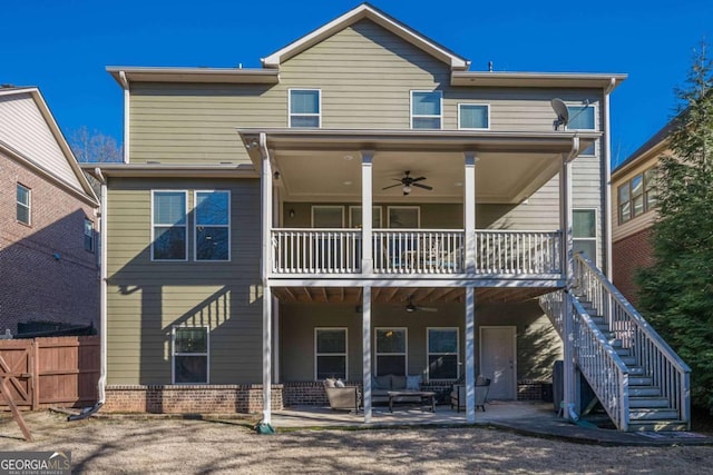 view of front of property featuring an outdoor living space, a patio area, a balcony, and ceiling fan