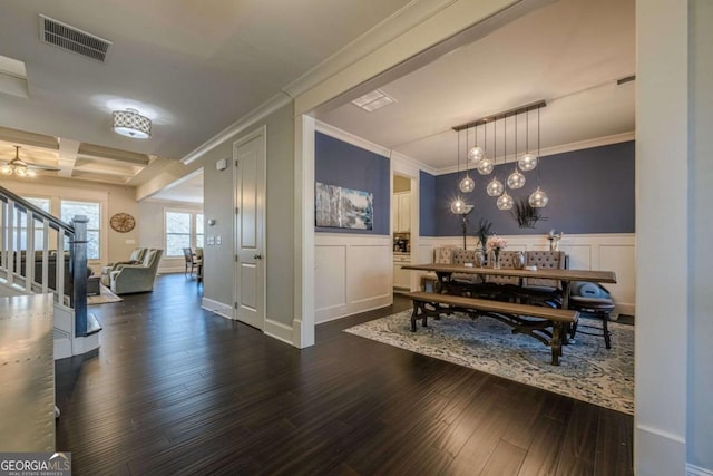 dining room with crown molding and dark wood-type flooring