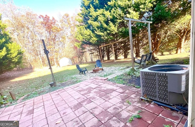 view of patio featuring central AC and an outdoor fire pit