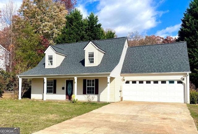 new england style home featuring a garage, covered porch, and a front yard