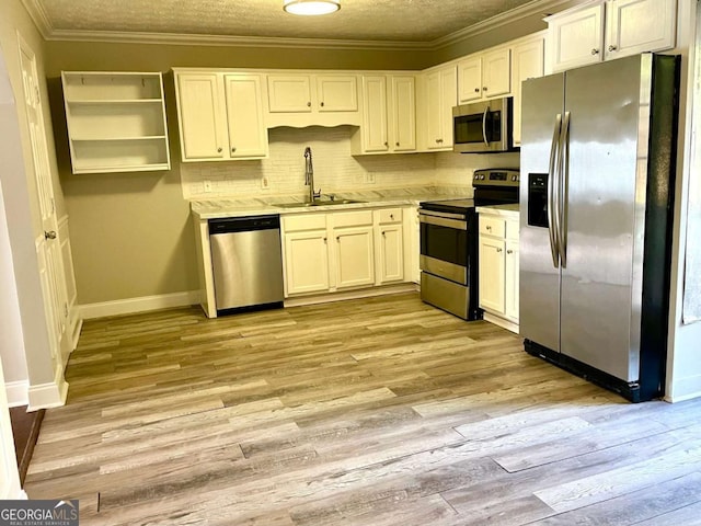 kitchen featuring white cabinetry, sink, crown molding, and appliances with stainless steel finishes