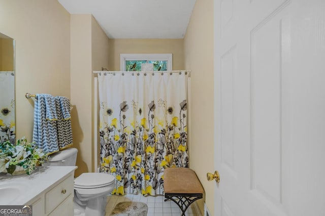 bathroom featuring vanity, curtained shower, tile patterned floors, and toilet