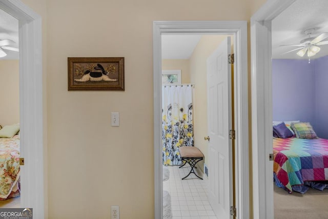 hall featuring light tile patterned floors