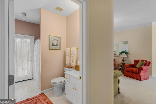 bathroom featuring vanity, ornamental molding, and toilet