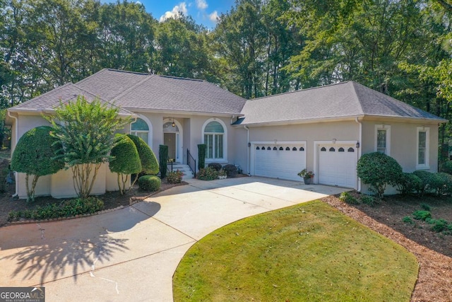 view of front of property featuring a garage and a front yard