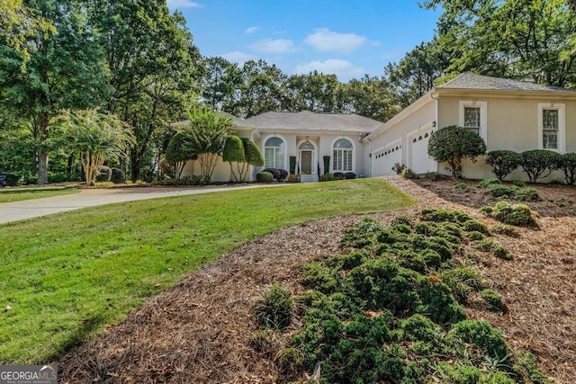 view of front of home featuring a garage and a front yard