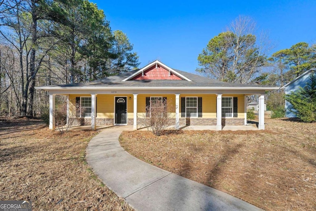 farmhouse inspired home featuring covered porch