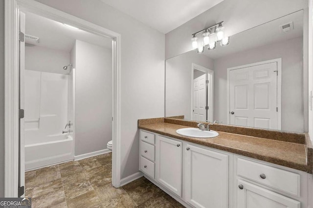 full bathroom with vanity, washtub / shower combination, and toilet