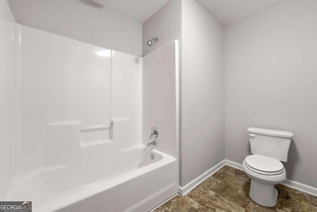 bathroom featuring toilet and bathing tub / shower combination