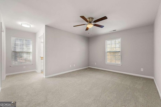 carpeted empty room featuring ceiling fan