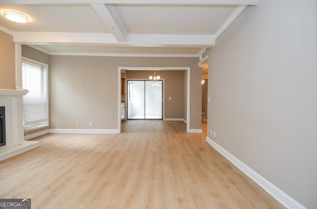 unfurnished living room featuring crown molding, beam ceiling, light hardwood / wood-style floors, and a chandelier