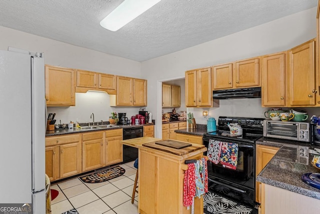 kitchen with light brown cabinetry, sink, light tile patterned floors, black appliances, and a textured ceiling