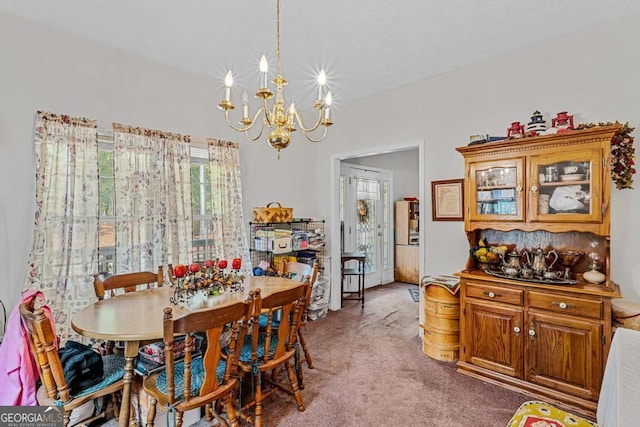 carpeted dining room featuring a chandelier