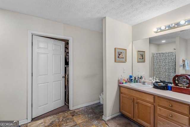 bathroom with vanity, a textured ceiling, and a shower with shower curtain