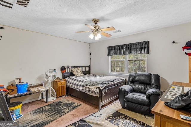 bedroom featuring carpet flooring, a textured ceiling, and ceiling fan