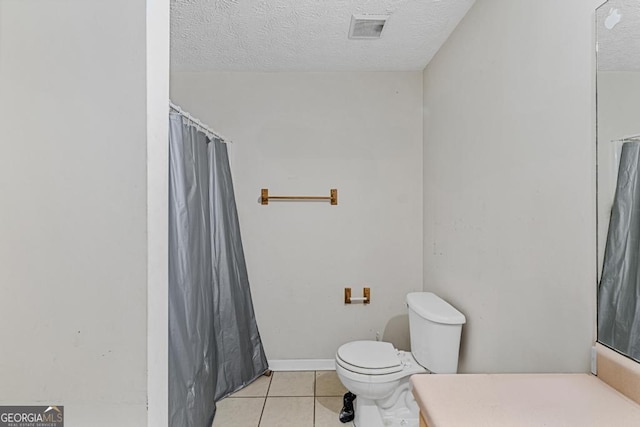 bathroom featuring vanity, tile patterned floors, a textured ceiling, and toilet