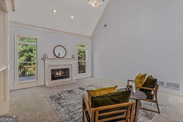 carpeted living room featuring crown molding and high vaulted ceiling