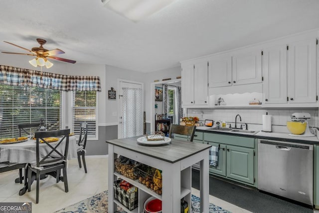 kitchen featuring a healthy amount of sunlight, sink, dishwasher, and green cabinets