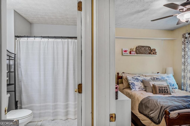 bedroom with a textured ceiling and ceiling fan