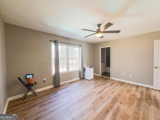 unfurnished bedroom featuring light hardwood / wood-style flooring, ceiling fan, and ensuite bathroom