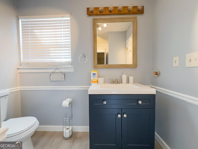 bathroom with vanity, hardwood / wood-style floors, and toilet