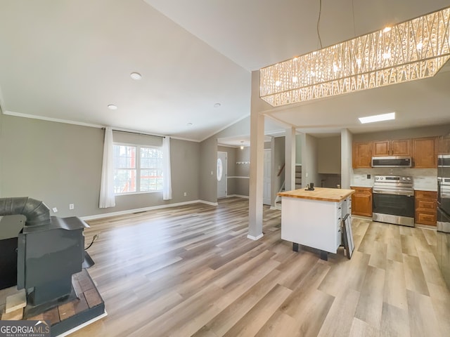 kitchen with stainless steel appliances, butcher block counters, and light wood-type flooring