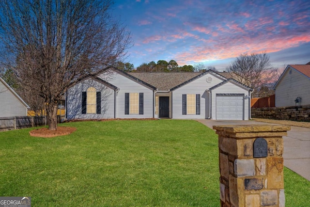 ranch-style house with a garage and a yard