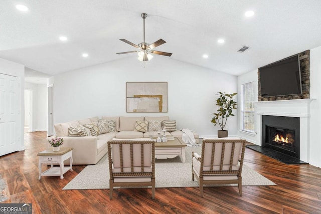 living room featuring ceiling fan, lofted ceiling, a large fireplace, and dark hardwood / wood-style floors