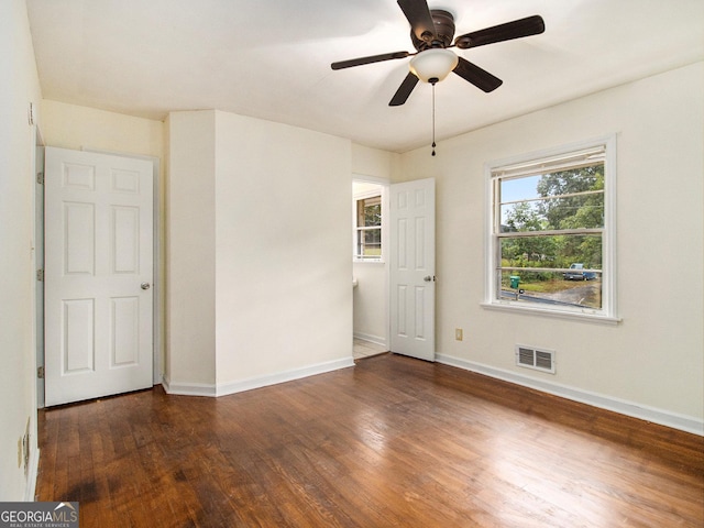 empty room featuring ceiling fan and dark hardwood / wood-style floors