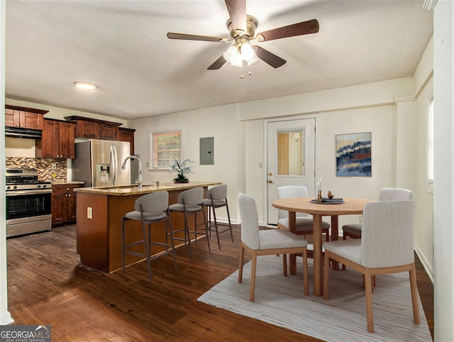 kitchen featuring stainless steel appliances, dark wood-type flooring, sink, and backsplash