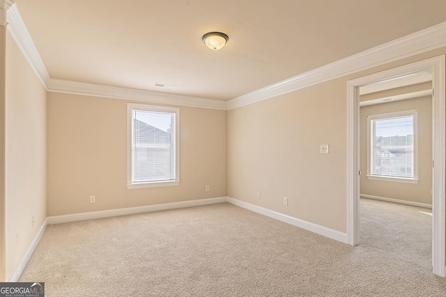 unfurnished room featuring light colored carpet and ornamental molding