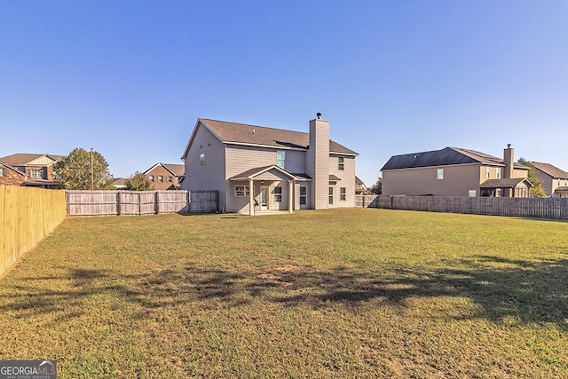 rear view of house with a lawn