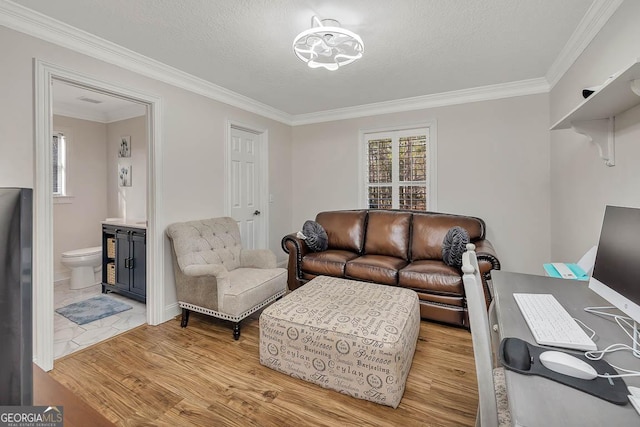 living room with a healthy amount of sunlight, crown molding, a textured ceiling, and wood finished floors