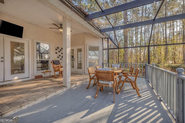 sunroom with a ceiling fan and lofted ceiling