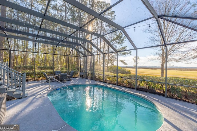 outdoor pool with a lanai and a patio area