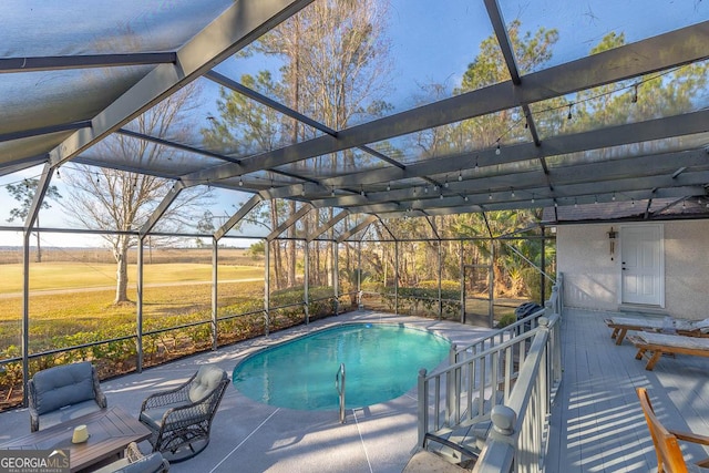 outdoor pool with a lanai and a patio area