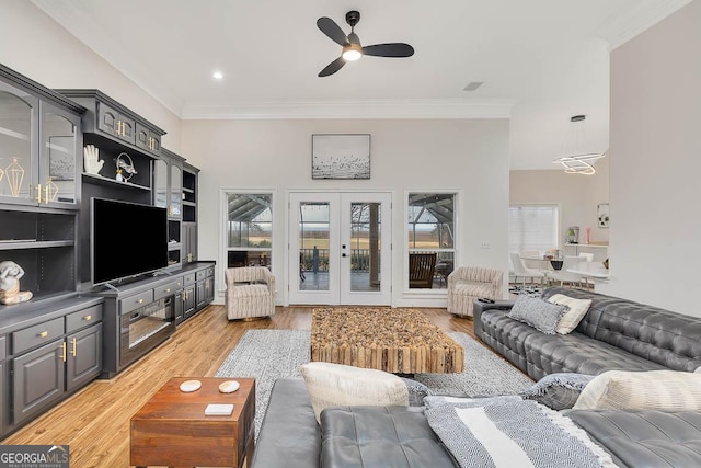 living area with ceiling fan, french doors, light wood-type flooring, and crown molding