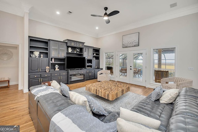 living area with french doors, light wood-type flooring, and visible vents