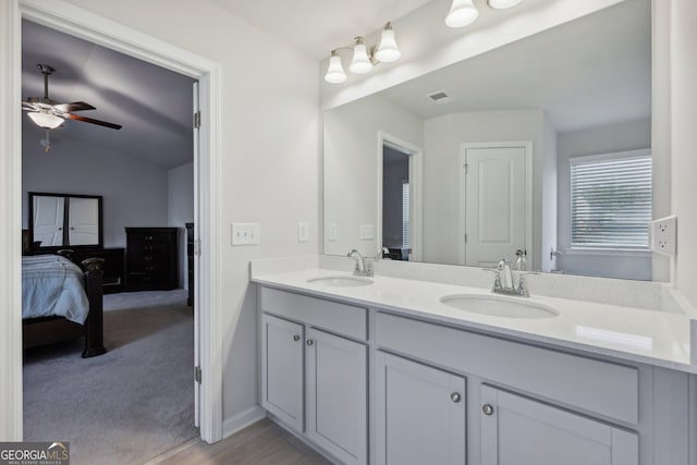 bathroom featuring vanity, vaulted ceiling, and ceiling fan