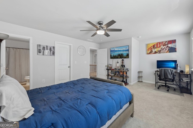 bedroom featuring carpet, ceiling fan, and ensuite bath