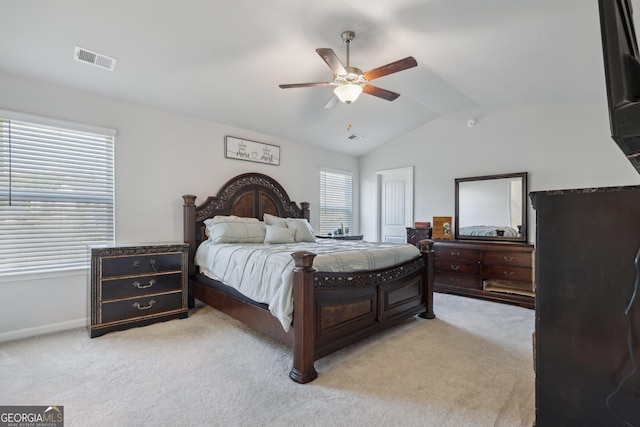 bedroom with ceiling fan, lofted ceiling, and light carpet