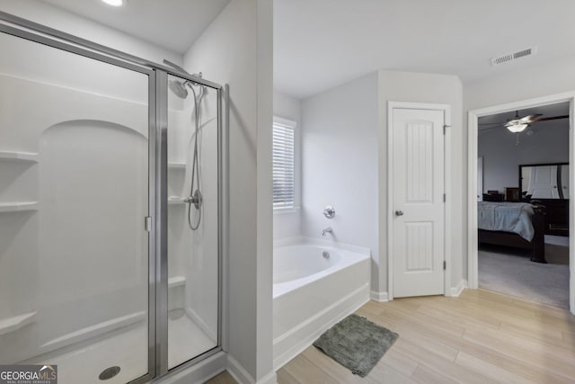 bathroom featuring independent shower and bath and hardwood / wood-style floors