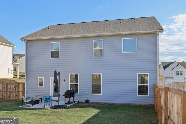 rear view of property featuring a lawn and a patio