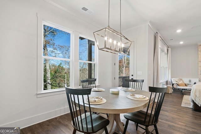 dining area featuring a chandelier, visible vents, dark wood-type flooring, and baseboards