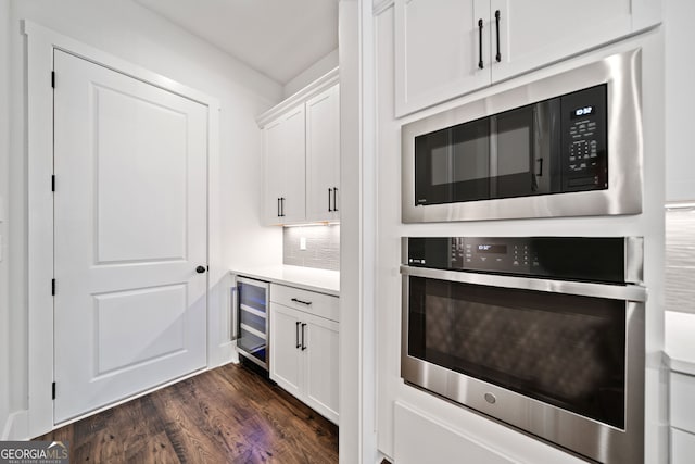 kitchen with stainless steel dishwasher, visible vents, a fireplace, a sink, and ceiling fan with notable chandelier