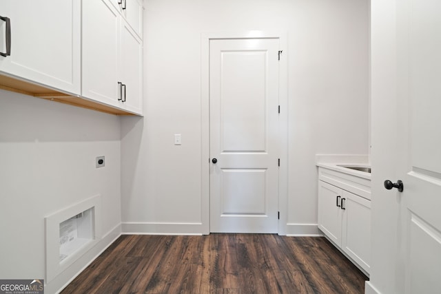 laundry room featuring electric dryer hookup, baseboards, cabinet space, and dark wood-style flooring