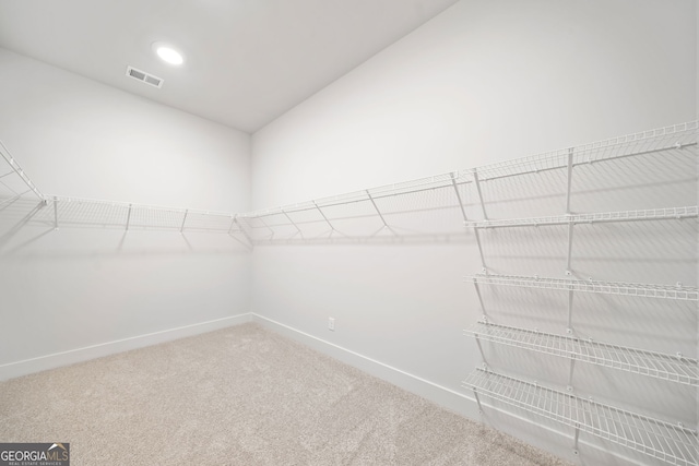 laundry room featuring baseboards, electric dryer hookup, cabinet space, and dark wood-type flooring