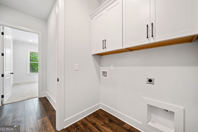 clothes washing area featuring cabinet space, hookup for a washing machine, dark wood finished floors, baseboards, and hookup for an electric dryer